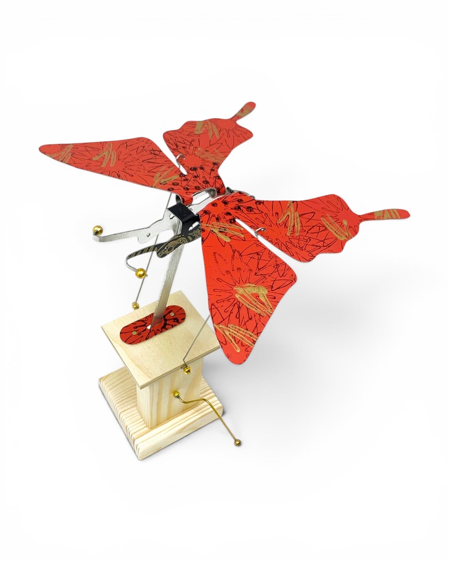 A butterfly-shaped hanging ornament with red patterned wings and a light wood stand, shown on a plain white background.