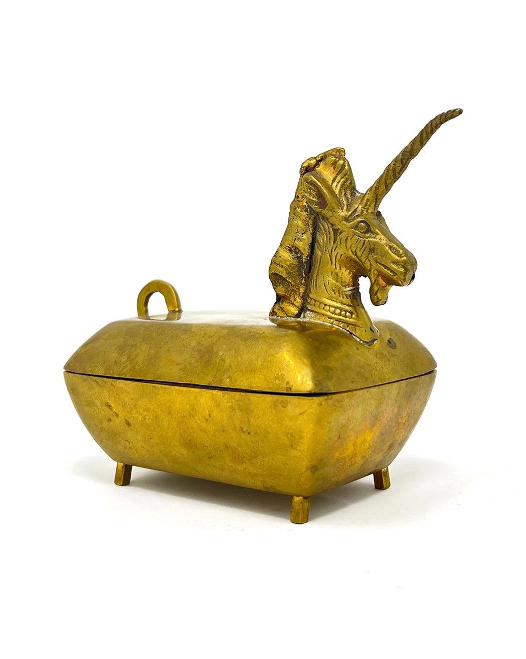 An antique brass unicorn-themed keepsake box with a lid featuring a sculpted unicorn head and a small top loop handle, set against a plain white background.