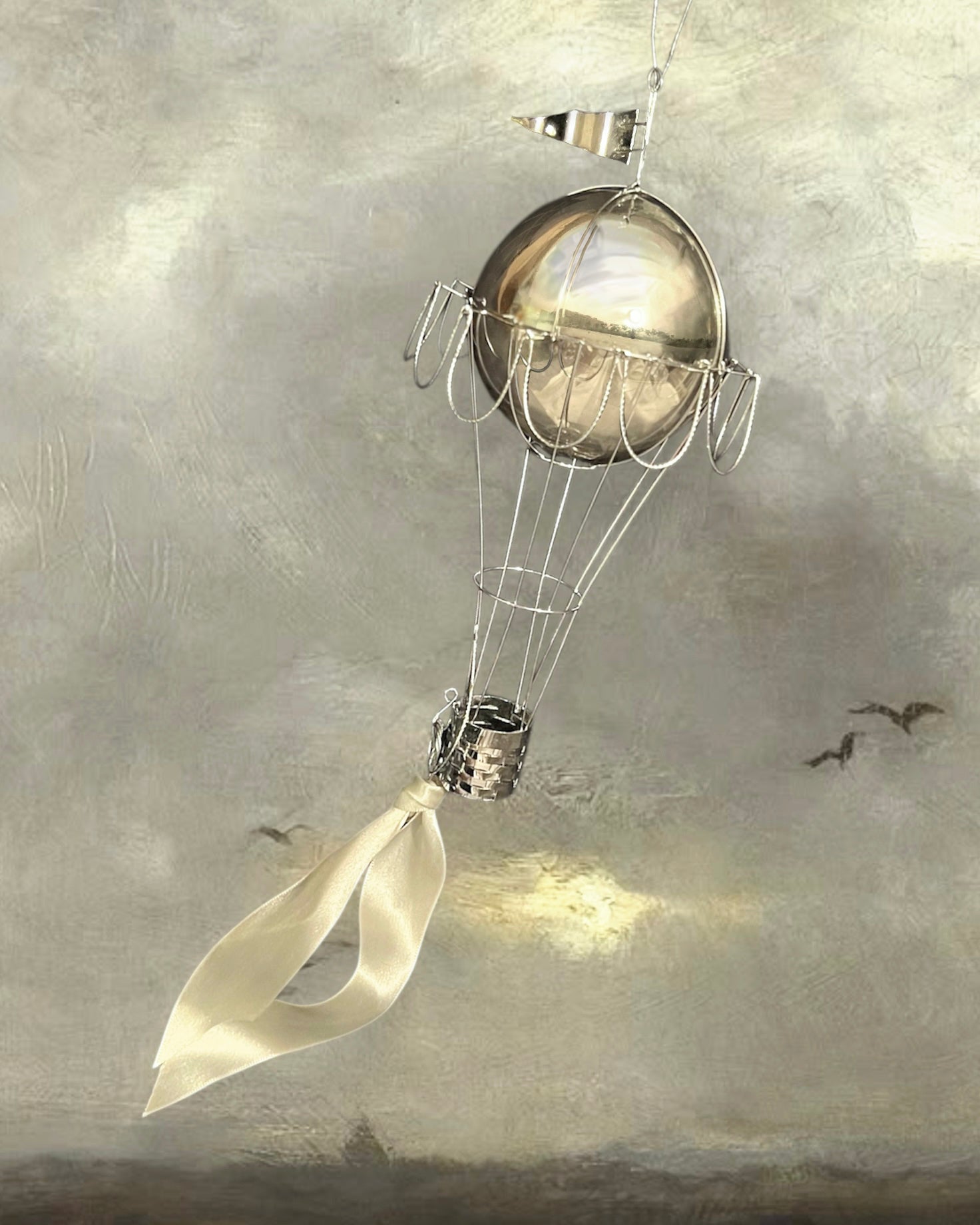 Decorative hot air balloon with a ribbon against a textured gray background