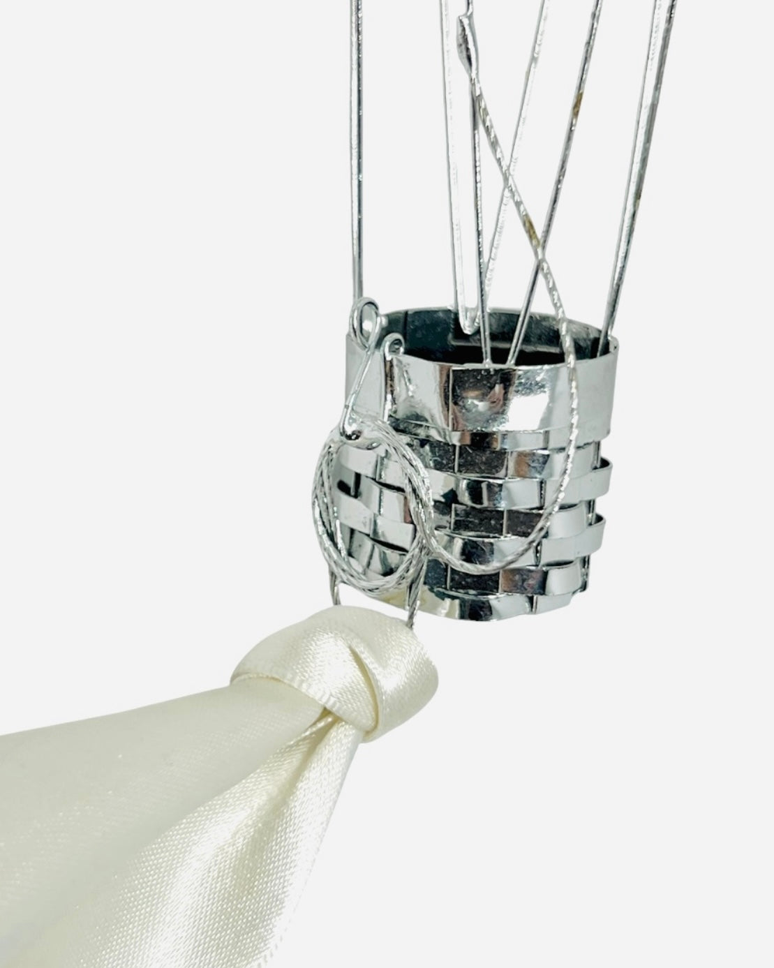 Silver decorative element with a ribbon on a white background