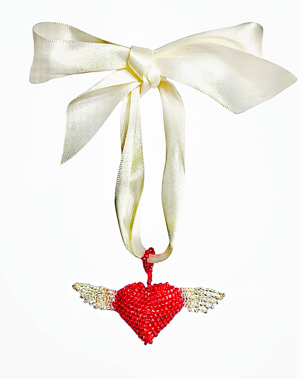 Red heart-shaped ornament with wings and a white ribbon on a white background